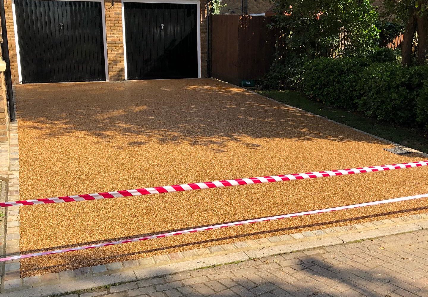 Gold resin bound driveway laid up to a double garage